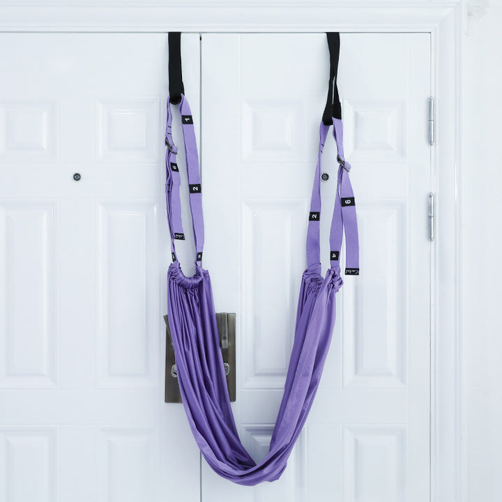 Woman stretching with a door yoga strap