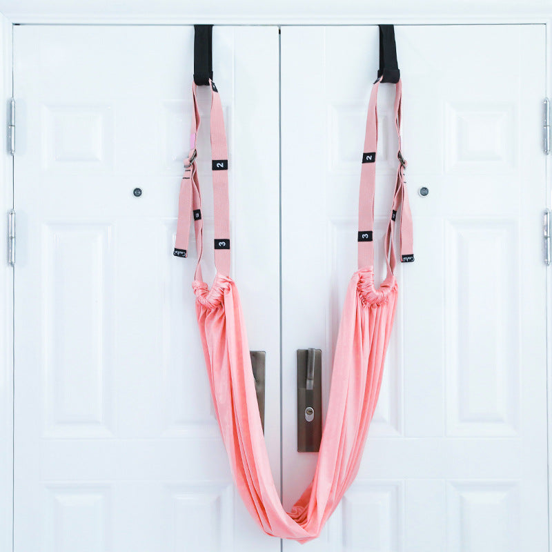 Woman stretching with a door yoga strap
